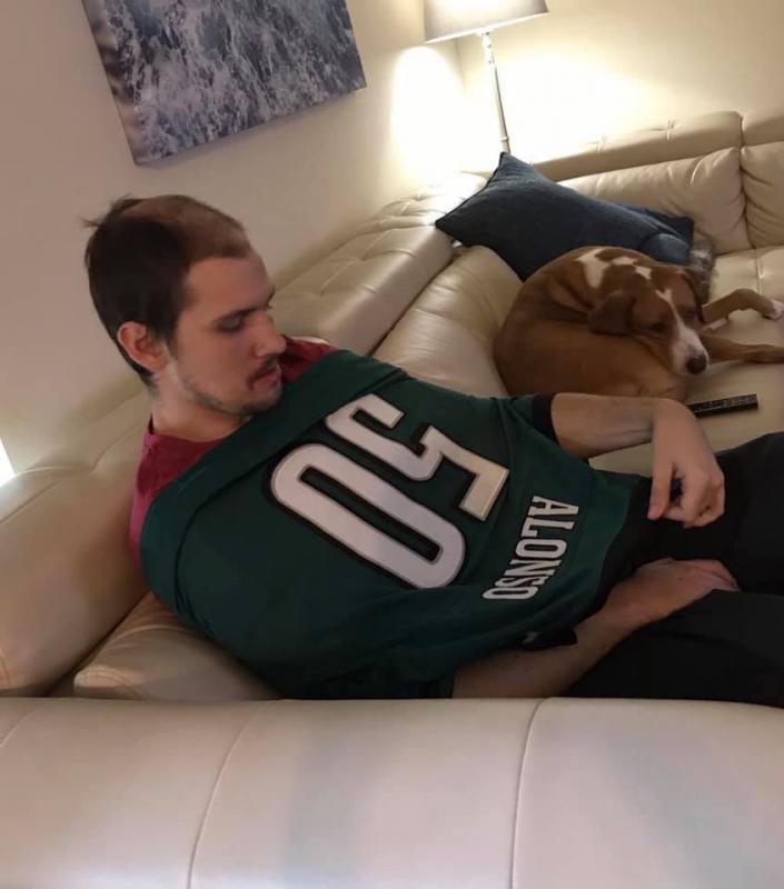 Jack McPike looks at his vintage Kiko Alonzo Eagles jersey all the way from Upper Chichester to Tampa. Charlie Dog is on the couch (it’s pronounced Cholly in Philly). SUBMITTED PHOTO